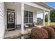 Cozy front porch with comfortable seating, a stylish front door, and vibrant landscaping at 81 Dot Ct, Fuquay Varina, NC 27526