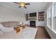 An inviting living room featuring a fireplace, built-in shelving, and a comfortable couch at 81 Dot Ct, Fuquay Varina, NC 27526