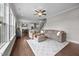 Open-concept living space featuring a large sectional couch, dining area, and gourmet kitchen at 81 Dot Ct, Fuquay Varina, NC 27526