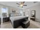 A primary bedroom featuring a king bed, a ceiling fan, and natural light at 81 Dot Ct, Fuquay Varina, NC 27526