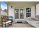 Inviting front porch area with comfortable seating and decor with double doors leading to the home's interior at 81 Dot Ct, Fuquay Varina, NC 27526