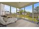Relaxing screened-in porch with comfortable daybed, open backyard views, and lots of light at 81 Dot Ct, Fuquay Varina, NC 27526