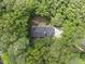 Aerial view of a home, showing its roof, surrounding trees, and driveway at 821 Ascot Ln, Raleigh, NC 27615