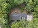 Aerial view of a house surrounded by lush greenery and mature trees at 821 Ascot Ln, Raleigh, NC 27615
