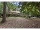 Secluded backyard with a deck, leafy foliage, and mature trees, providing privacy at 821 Ascot Ln, Raleigh, NC 27615