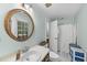 Bright bathroom featuring a circular mirror, tile flooring, and a shower with curtain at 821 Ascot Ln, Raleigh, NC 27615