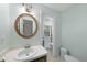 Bathroom features a sink, mirror and view to a second bathroom with white tiling at 821 Ascot Ln, Raleigh, NC 27615