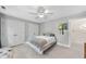 Neutral bedroom with a ceiling fan, double closets, and light-colored flooring at 821 Ascot Ln, Raleigh, NC 27615