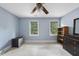 Bright bedroom with two windows, ceiling fan, and painted pale blue walls, plus modern decor at 821 Ascot Ln, Raleigh, NC 27615