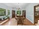 Formal dining room featuring hardwood floors, a chandelier, and large windows at 821 Ascot Ln, Raleigh, NC 27615