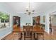 Beautiful dining room with hardwood floors, chandelier and large windows with views at 821 Ascot Ln, Raleigh, NC 27615