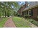 Brick home featuring a beautiful walkway surrounded by lush landscaping at 821 Ascot Ln, Raleigh, NC 27615
