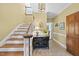 Inviting foyer with wood floors and staircase that leads to the second floor at 821 Ascot Ln, Raleigh, NC 27615
