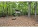 Backyard play area with a wooden playset, slide, and swing set, surrounded by trees at 821 Ascot Ln, Raleigh, NC 27615