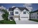 A charming two-story home with a three-car garage, landscaped yard, and a beautiful architectural design at 85 Guardian St, Youngsville, NC 27596