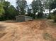 View of the side of the home, deck and the spacious backyard at 8505 Ray Rd, Raleigh, NC 27613