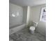 Clean bathroom showcasing a new bathtub and toilet, complemented by stylish marble tile flooring at 8505 Ray Rd, Raleigh, NC 27613