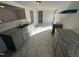 Modern kitchen boasting sleek gray cabinetry, granite countertops, and new flooring, ready for culinary adventures at 8505 Ray Rd, Raleigh, NC 27613
