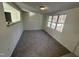 Bright living room featuring large windows and new carpet, offering a cozy and inviting atmosphere at 8505 Ray Rd, Raleigh, NC 27613