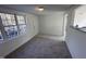 Cozy living room with new paint, new carpet, and plenty of natural light at 8505 Ray Rd, Raleigh, NC 27613