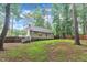 View of the backyard featuring the home's exterior, deck, fenced in yard and mature trees at 8801 Valley Hill Ct, Apex, NC 27539