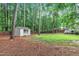 A storage shed and fenced-in backyard with mature trees at 8801 Valley Hill Ct, Apex, NC 27539