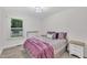 Comfortable bedroom design features a queen bed, wood flooring and a street view at 8801 Valley Hill Ct, Apex, NC 27539