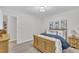 Comfortable bedroom featuring a wooden bed, drawers, closet access and natural light at 8801 Valley Hill Ct, Apex, NC 27539