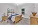 Charming bedroom with a wooden bed frame, dresser and a view of the front yard at 8801 Valley Hill Ct, Apex, NC 27539