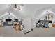 Bright and spacious bonus room featuring vaulted ceilings, ceiling fans, and ample space for a home office and gaming area at 8801 Valley Hill Ct, Apex, NC 27539