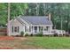 Charming single-story home featuring a cozy front porch, landscaped yard, and classic architectural details at 8801 Valley Hill Ct, Apex, NC 27539