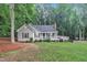 Inviting single-story home with a charming front porch, set in a peaceful, wooded neighborhood at 8801 Valley Hill Ct, Apex, NC 27539