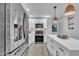 Well-equipped kitchen with stainless steel appliances, white cabinets, subway tile backsplash, and stylish pendant lighting at 8801 Valley Hill Ct, Apex, NC 27539