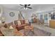 Open-concept living area with stylish decor, hardwood floors, and a dining area in the background at 8801 Valley Hill Ct, Apex, NC 27539