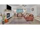 Bright living room featuring a cozy fireplace, wood floors, and ample seating at 8801 Valley Hill Ct, Apex, NC 27539