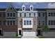 Charming townhome exterior featuring brick facade, white trim, and a two car garage at 952 Westerland Way # 142, Durham, NC 27703