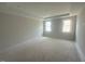 An empty bedroom featuring two large windows and neutral paint at 10 Slippery Elm Rd, Youngsville, NC 27596