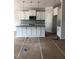Kitchen featuring white cabinets, granite countertops, gray backsplash and stainless steel appliances at 10 Slippery Elm Rd, Youngsville, NC 27596
