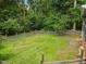 Large grassy backyard enclosed by wooden fencing offers lots of green space and privacy at 105 Hanna St, Carrboro, NC 27510
