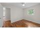 This bedroom features hardwood floors, a ceiling fan, and a sun-filled window at 105 Hanna St, Carrboro, NC 27510