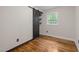 Bedroom with a wood sliding door closet, hardwood floors, and a window at 105 Hanna St, Carrboro, NC 27510