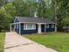 Inviting single-story home with a well-maintained lawn, paved driveway, and cozy front porch entrance at 105 Hanna St, Carrboro, NC 27510