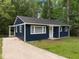 Charming blue home with a well-manicured lawn and inviting curb appeal at 105 Hanna St, Carrboro, NC 27510