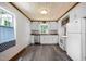 Bright kitchen with white cabinets, stainless steel appliances, and stylish flooring at 105 Hanna St, Carrboro, NC 27510