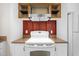 Close up of range with stainless vent hood, granite countertops and rustic wood backsplash at 105 Hanna St, Carrboro, NC 27510