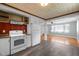 A well-lit kitchen featuring white appliances, stylish floor, and a red accent wall at 105 Hanna St, Carrboro, NC 27510