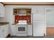 A kitchen with neutral counters and flooring, with white cabinets and appliances at 105 Hanna St, Carrboro, NC 27510