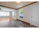 Living room connected to kitchen area, both with stylish floors and neutral wall colors at 105 Hanna St, Carrboro, NC 27510