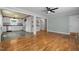 Open-concept living room with hardwood floors connected to a kitchen with white cabinets at 105 Hanna St, Carrboro, NC 27510