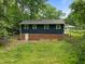 Spacious backyard and walk-out basement can be seen in this image of the back of this home at 105 Hanna St, Carrboro, NC 27510